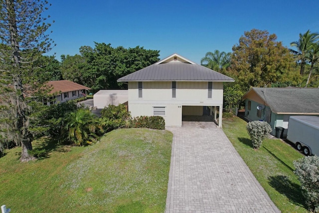 view of front facade with a front yard and a carport