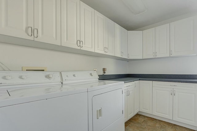 washroom featuring washer and dryer and cabinets