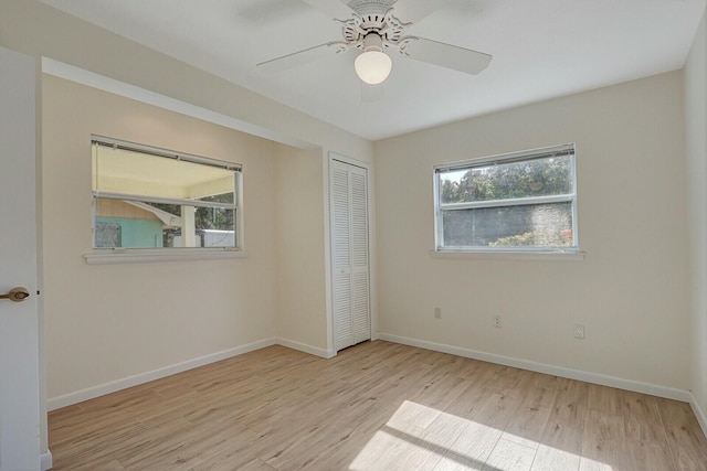 unfurnished bedroom with ceiling fan, a closet, and light hardwood / wood-style flooring