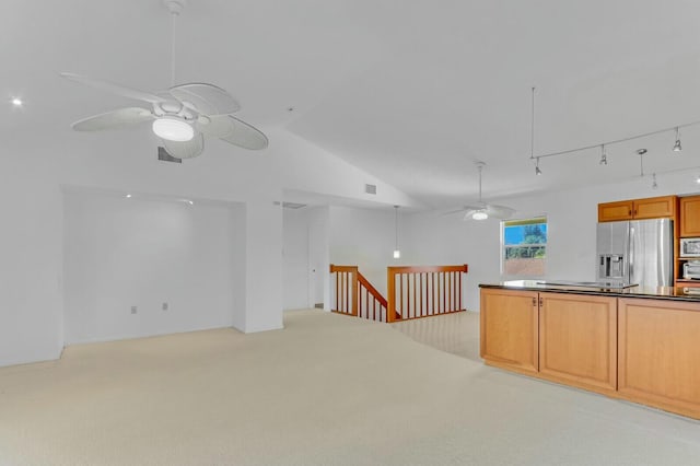 interior space with rail lighting, ceiling fan, and lofted ceiling