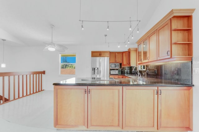 kitchen featuring kitchen peninsula, light brown cabinetry, stainless steel appliances, and sink