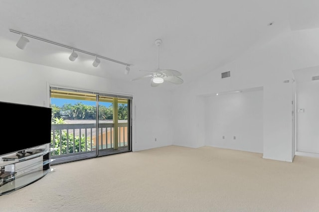 unfurnished living room with carpet flooring, ceiling fan, high vaulted ceiling, and track lighting