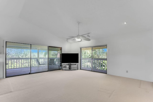 unfurnished living room with carpet flooring, ceiling fan, and high vaulted ceiling