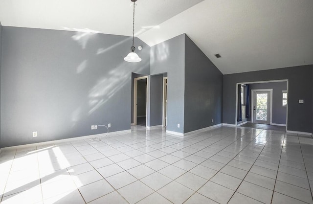 interior space featuring light tile patterned flooring and high vaulted ceiling