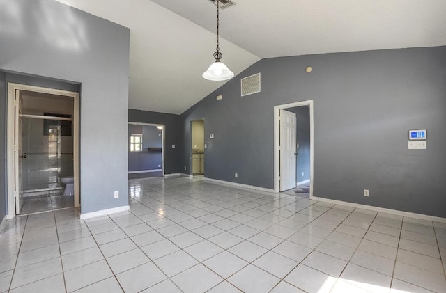 unfurnished room featuring high vaulted ceiling and light tile patterned flooring