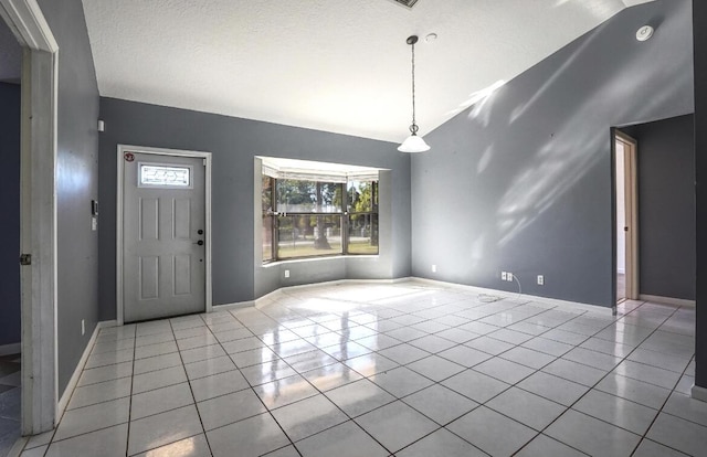 tiled entrance foyer with a textured ceiling