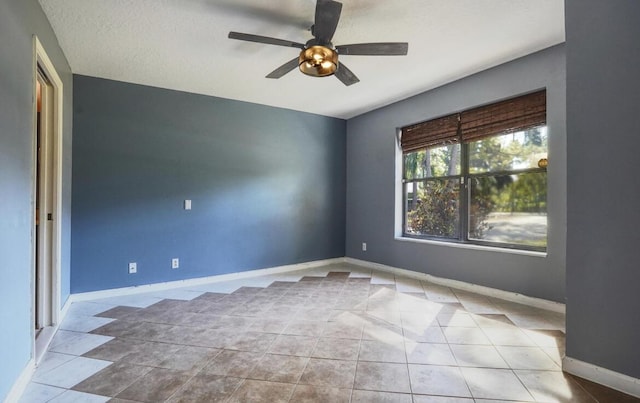 unfurnished room featuring ceiling fan, light tile patterned floors, and a textured ceiling