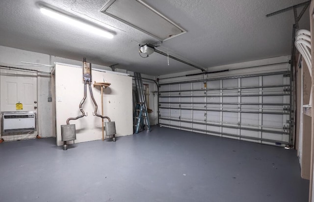 garage featuring heating unit and a garage door opener