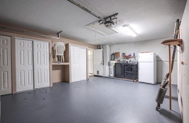 garage with electric water heater, white fridge, a garage door opener, and independent washer and dryer