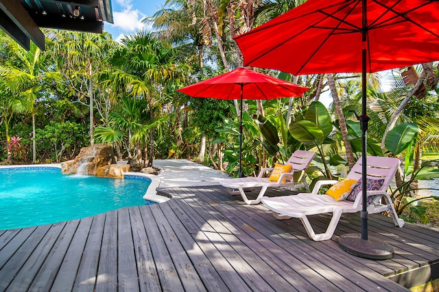 view of pool featuring pool water feature and a wooden deck