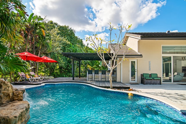 view of pool featuring a pergola and a wooden deck