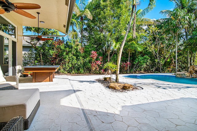 view of swimming pool featuring a jacuzzi, ceiling fan, and a patio area