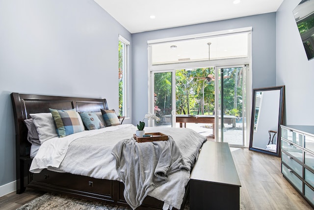 bedroom featuring access to outside, light hardwood / wood-style floors, and pool table