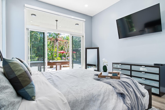 bedroom with access to outside and light hardwood / wood-style flooring