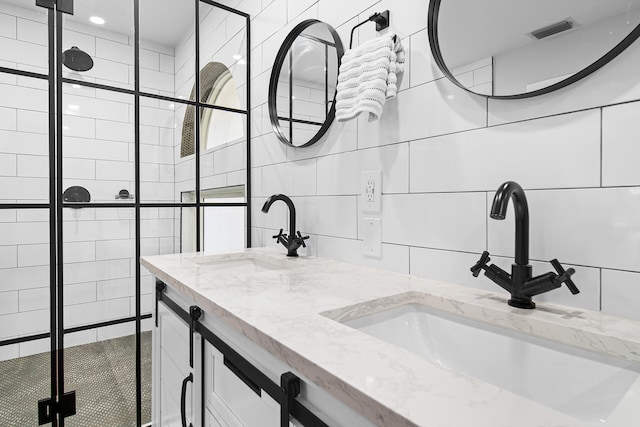 bathroom featuring vanity and tile walls