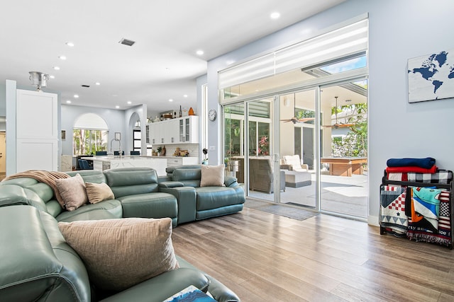 living room featuring light hardwood / wood-style flooring and sink