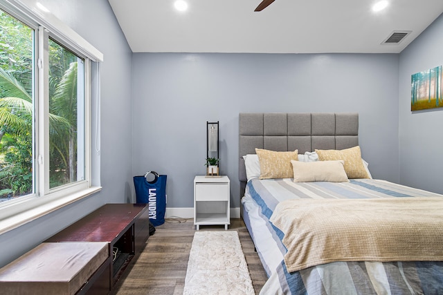 bedroom featuring ceiling fan, dark wood-type flooring, and vaulted ceiling