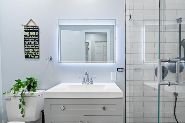 bathroom with vanity, toilet, and walk in shower