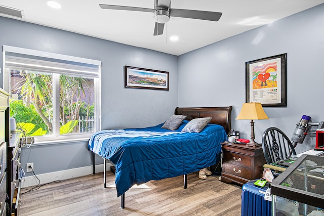 bedroom with ceiling fan and light hardwood / wood-style floors