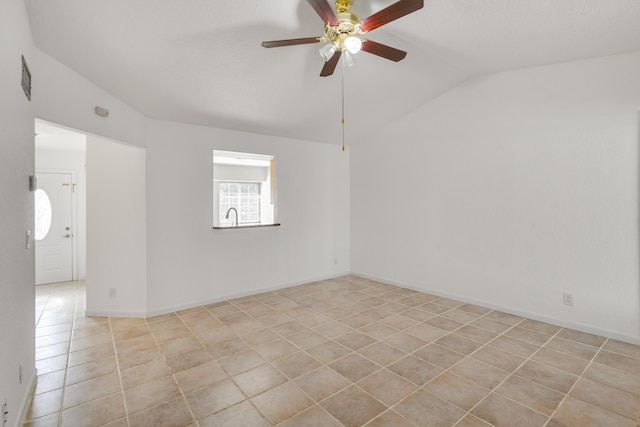 tiled empty room with ceiling fan and vaulted ceiling