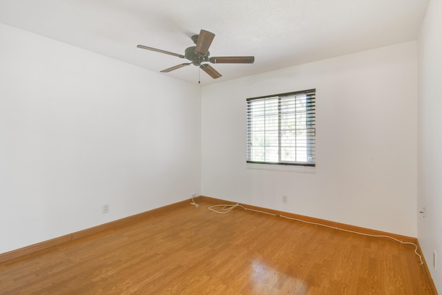 spare room featuring hardwood / wood-style flooring and ceiling fan