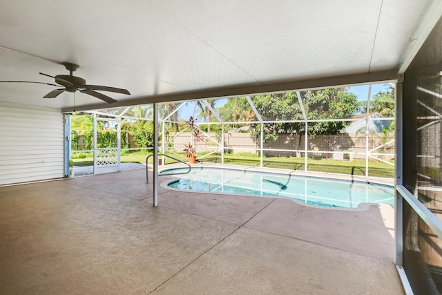 view of pool featuring a lanai, a patio, ceiling fan, and a lawn