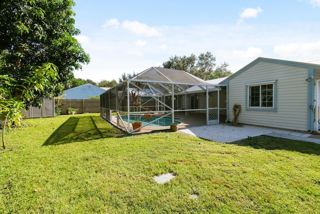 view of yard with a lanai, a storage shed, a fenced in pool, and a patio area