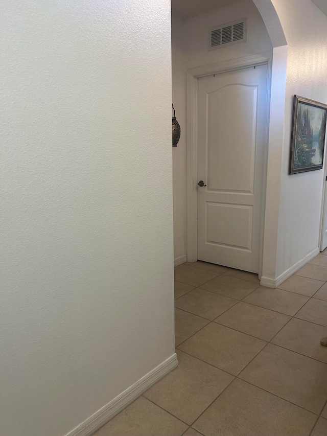 corridor with light tile patterned flooring