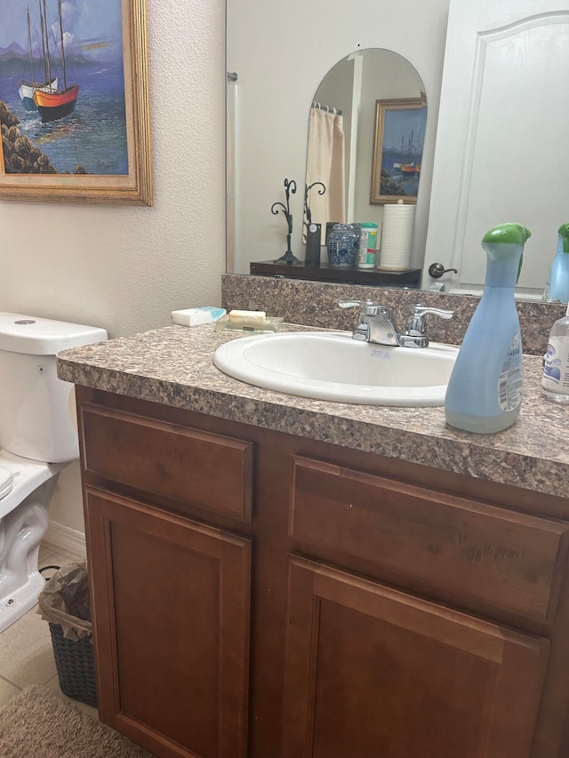 bathroom featuring vanity and toilet