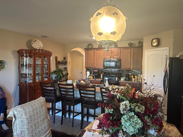 tiled dining room with sink