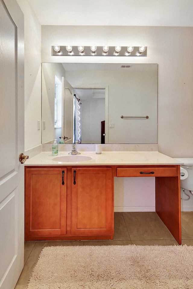 bathroom with tile patterned floors and vanity