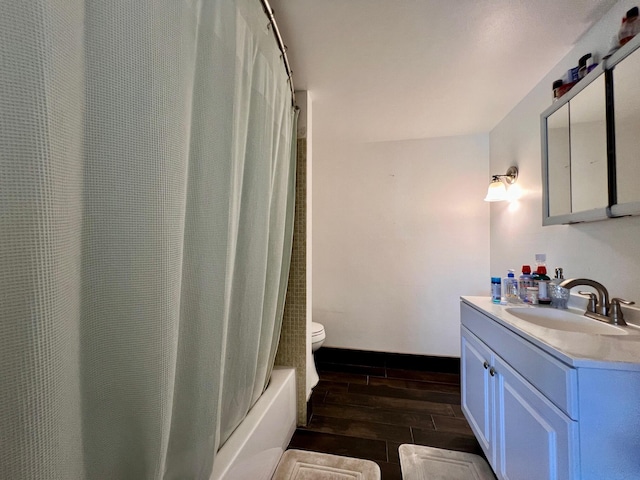 bathroom with toilet, vanity, and hardwood / wood-style flooring