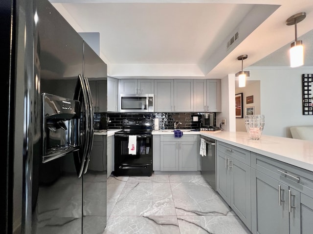 kitchen with decorative backsplash, decorative light fixtures, gray cabinetry, and black appliances