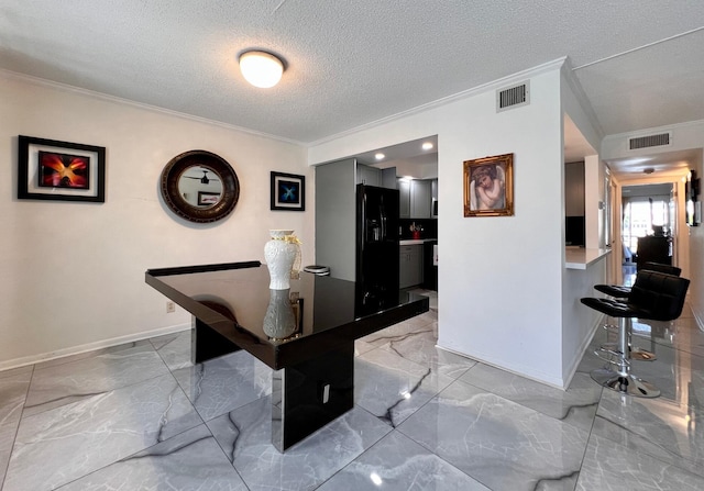 game room with crown molding and a textured ceiling