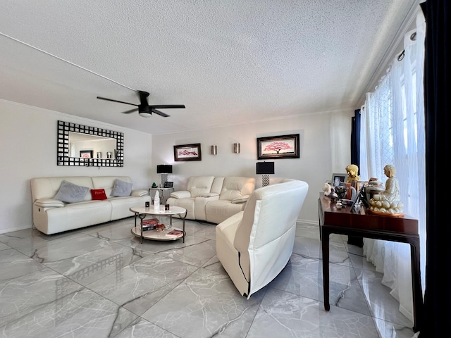 living room featuring ceiling fan and a textured ceiling