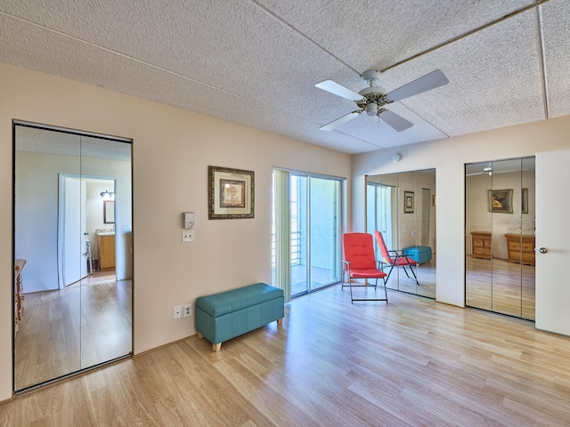 unfurnished room with a textured ceiling, light hardwood / wood-style floors, and ceiling fan