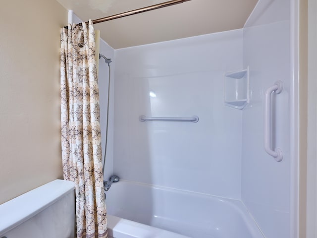 bathroom featuring shower / bath combo and toilet