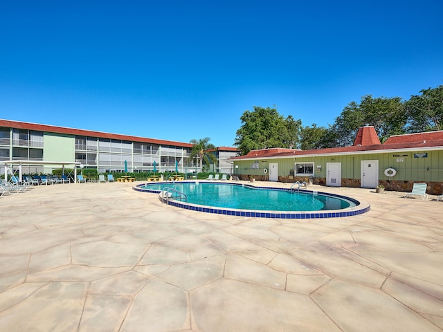 view of swimming pool with a patio