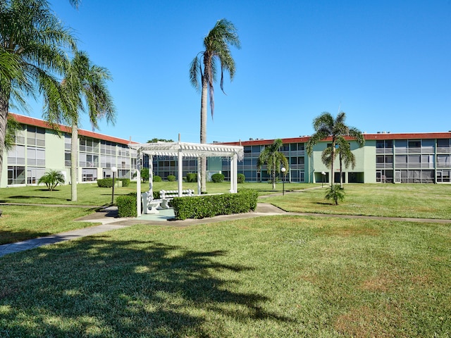 view of property's community with a pergola and a yard