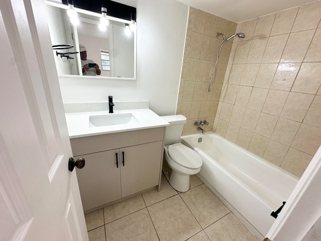 full bathroom featuring vanity, tiled shower / bath combo, tile patterned floors, and toilet