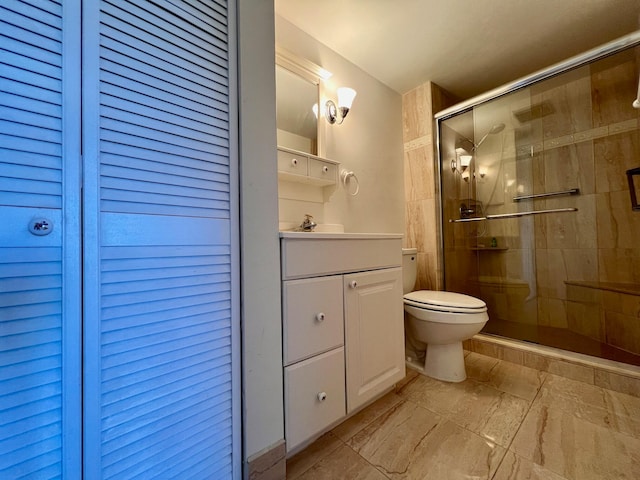 bathroom featuring vanity, toilet, and walk in shower