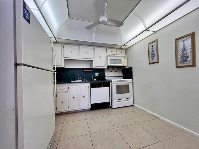 kitchen featuring white cabinets, decorative backsplash, white appliances, and light tile patterned floors