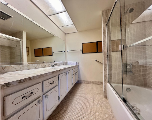 bathroom featuring vanity, tile patterned floors, and bath / shower combo with glass door