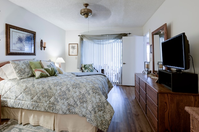 bedroom with a textured ceiling, dark hardwood / wood-style flooring, and ceiling fan