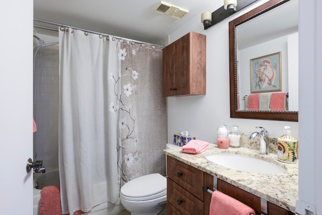 full bathroom featuring vanity, shower / tub combo, and toilet