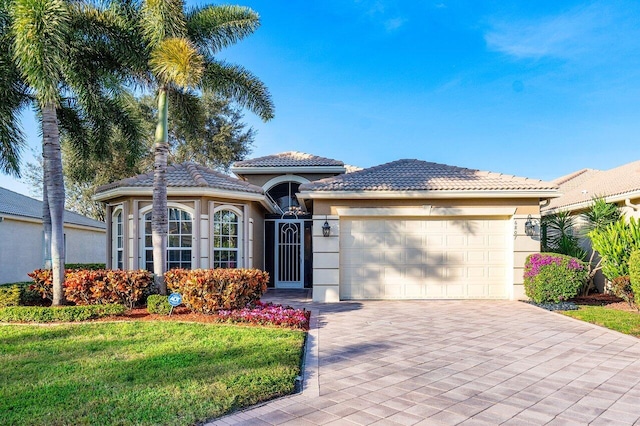 mediterranean / spanish-style house with a front yard and a garage