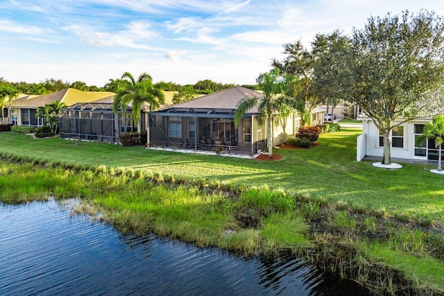 back of property featuring glass enclosure, a water view, and a yard