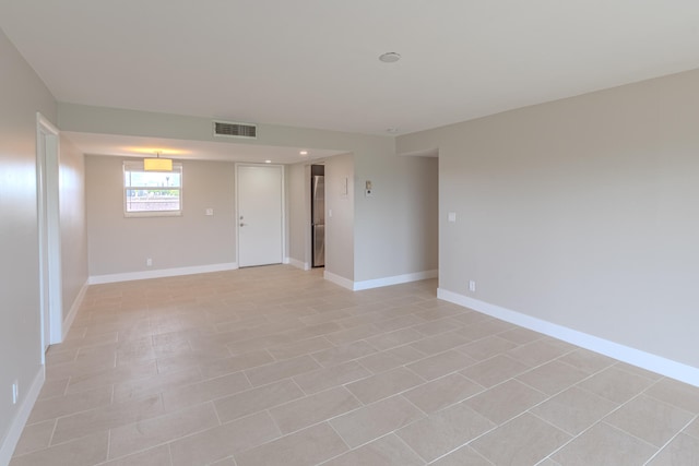 empty room with light tile patterned flooring