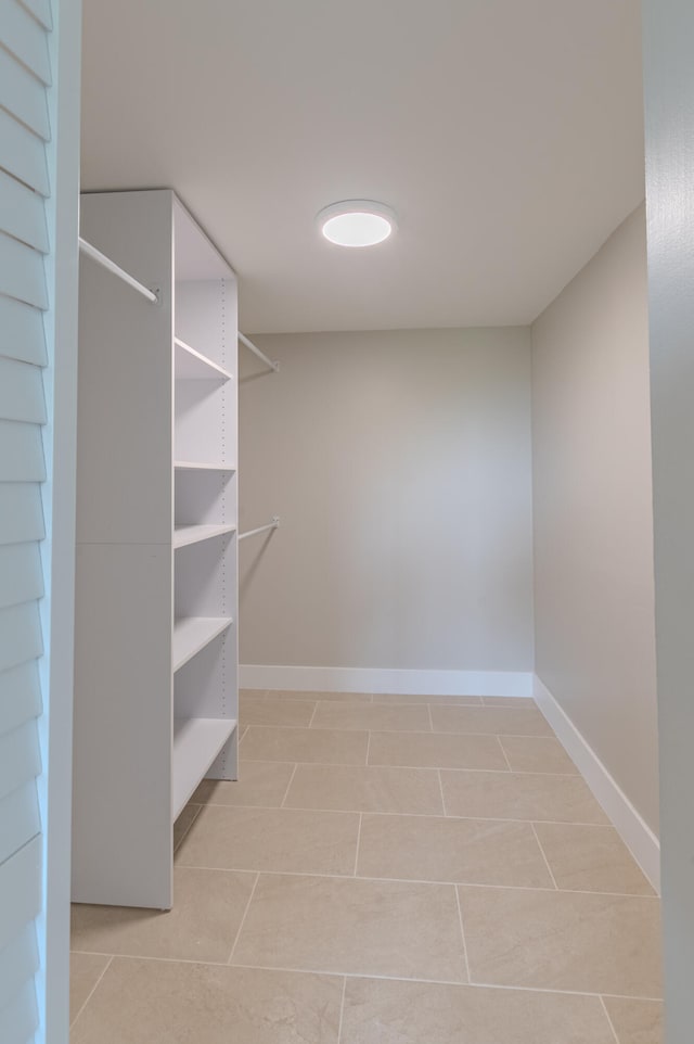 spacious closet with light tile patterned flooring