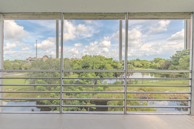 unfurnished sunroom with a water view